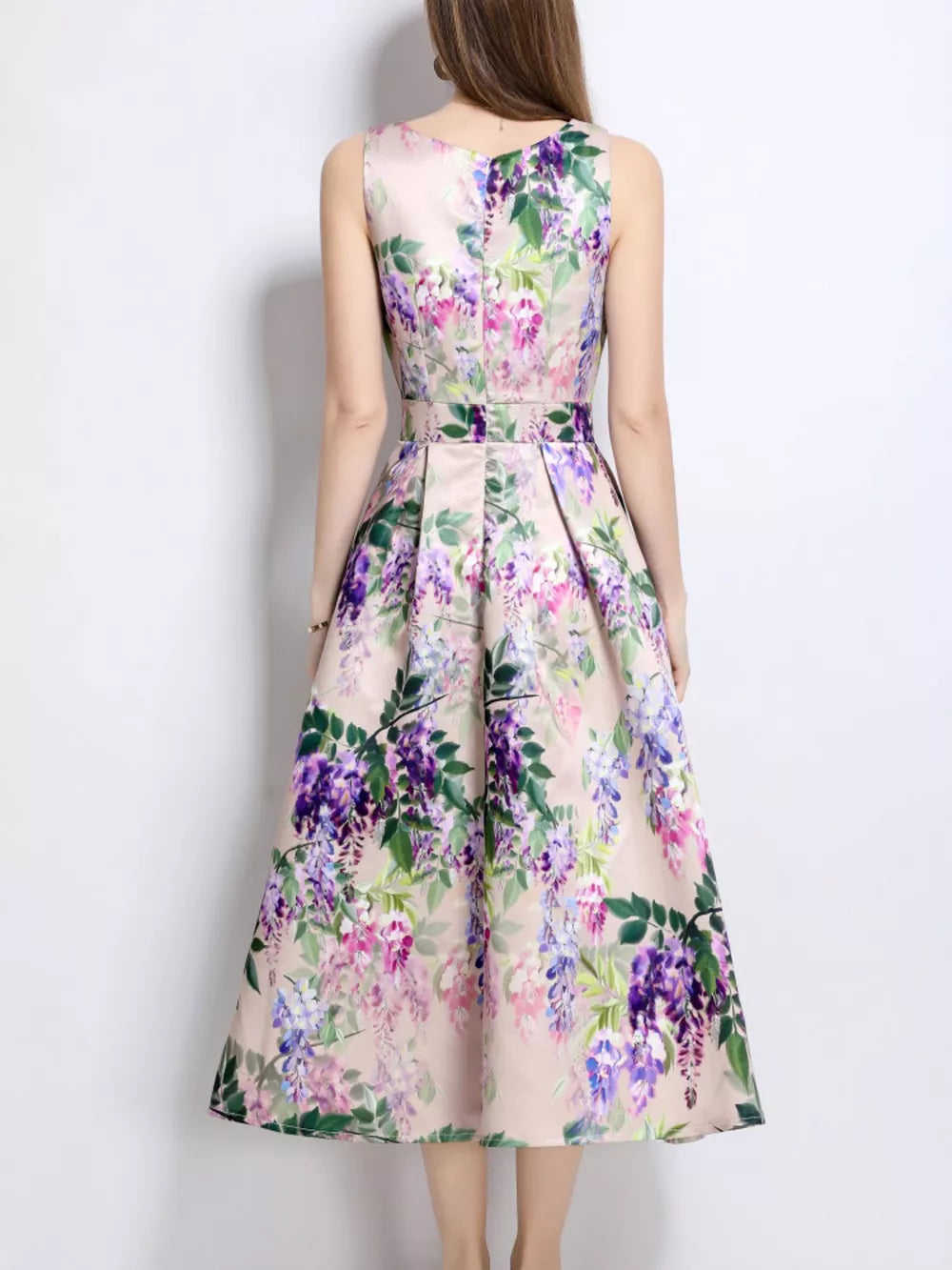 Blush pink a-line midi dress with wisteria floral print, sleeveless, and pleated skirt.