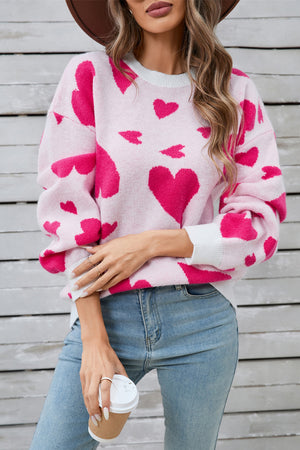 Pink and white intarsia heart knit jumper with crew neck and long sleeves.