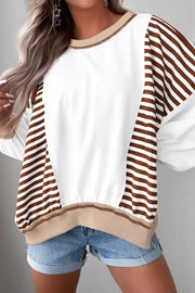 Chic colorblock sweatshirt with white body and brown striped sleeves, contrast stitching detail.