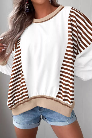 Chic colorblock sweatshirt with white body and brown striped sleeves, contrast stitching detail.