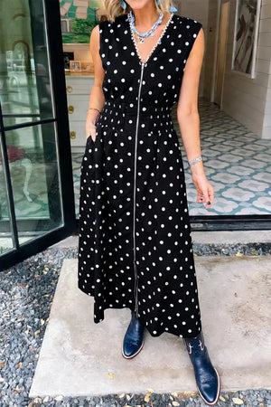 Black polka dot midi dress with zipper, smocked waist, and pockets