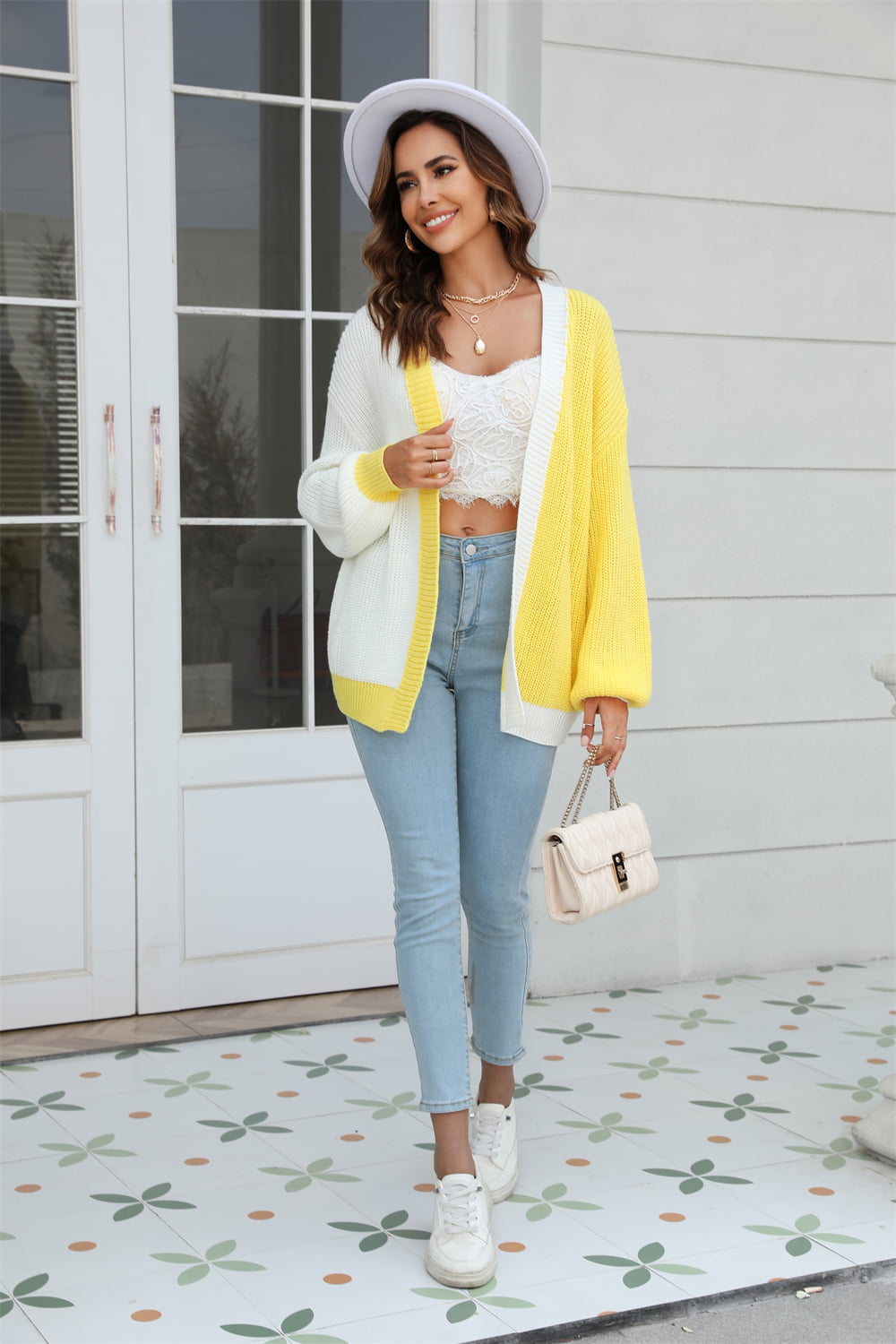 Colorblock knit cardigan in yellow and white with contrast trim, featuring balloon sleeves.
