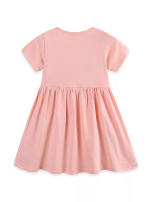 Pink cotton toddler dress with short sleeves, gathered waist, and appliqué detail.
