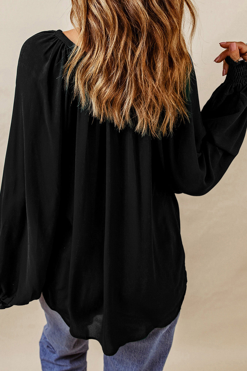 Black ruched cuff voluminous sleeve blouse with gathered neckline detail.