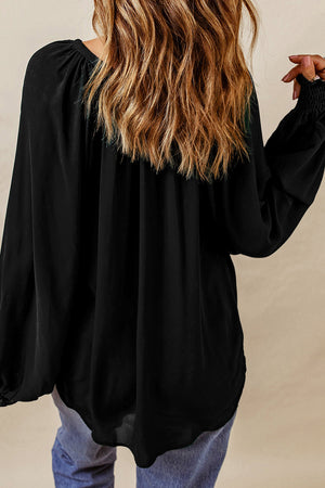 Black ruched cuff voluminous sleeve blouse with gathered neckline detail.