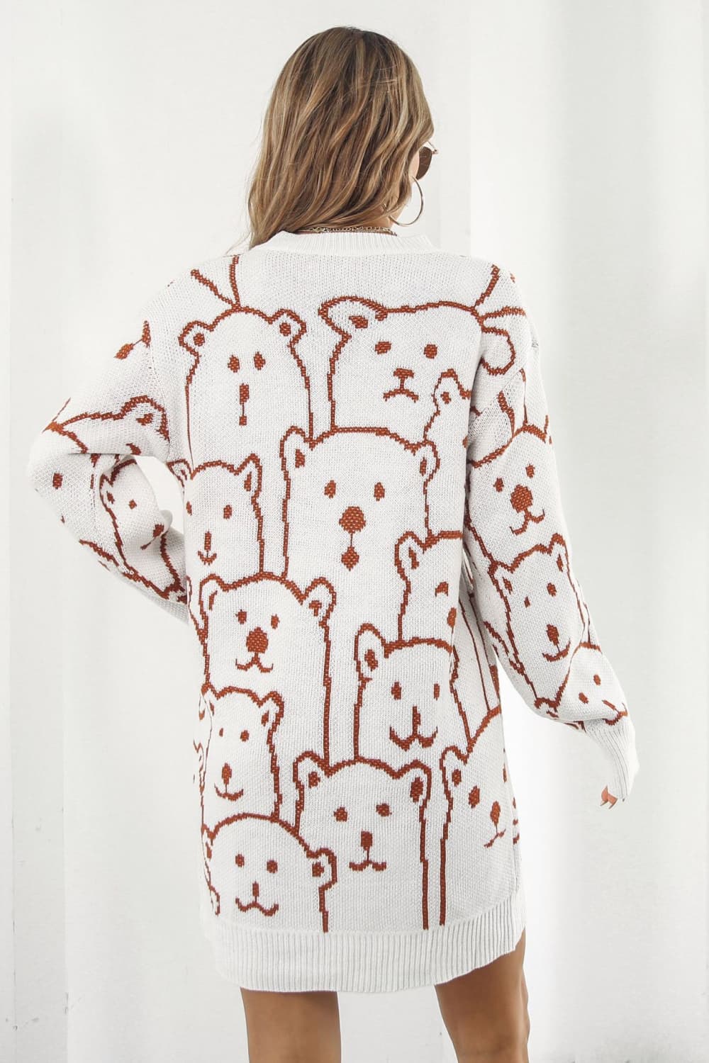 White knit dress with allover brown bear motif, crew neck, long sleeves.