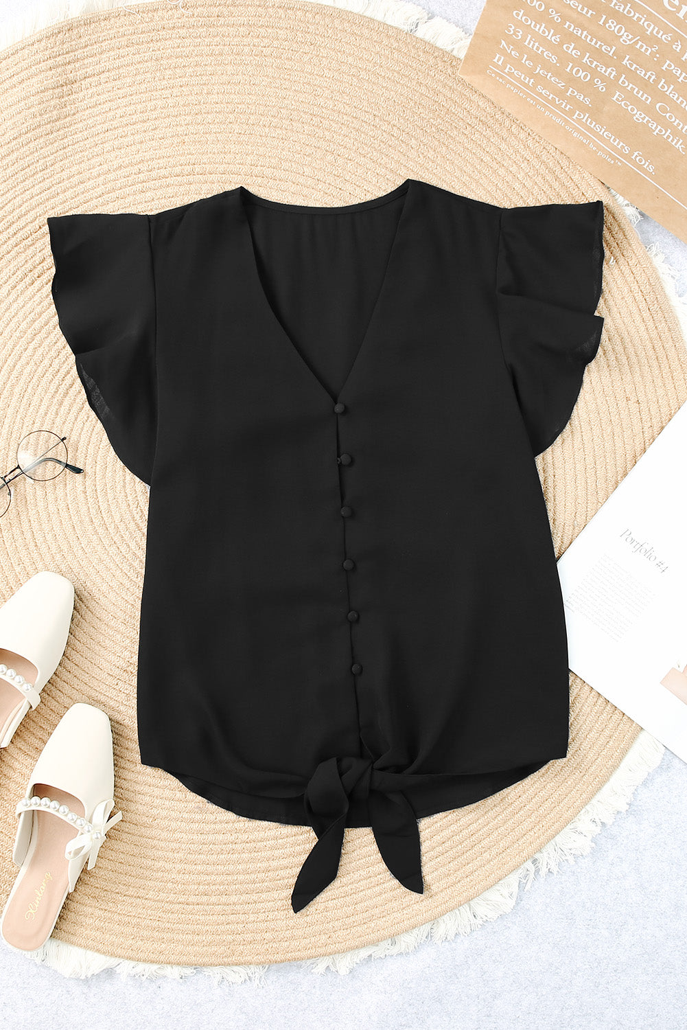 Black button-down blouse with ruffle sleeves and a tie-front detail