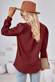 Textured puff sleeve henley blouse in Rust with a diamond pattern.