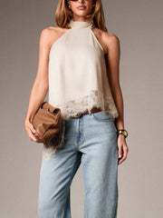 Beige halter camisole with lace trim and mock neck, styled with jeans.
