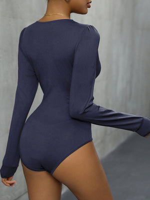 Long sleeve blue bodysuit with puff shoulder detail and lace trim.