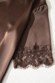 Brown satin maternity blouse with lace trim detail on the sleeve hem.