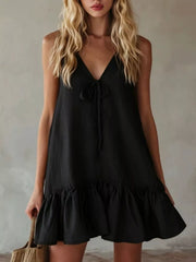 Black mini dress with tie-front V-neck and ruffle hem.
