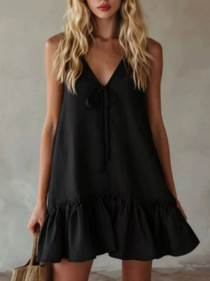 Black mini dress with tie-front V-neck and ruffle hem.