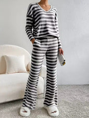 Black striped knit loungewear set with v-neck top and wide-leg pants.
