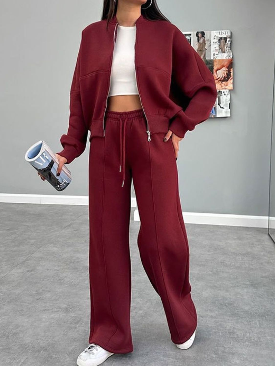 Crimson bomber jacket and wide-leg tracksuit with drawstring waist and zipper detail.