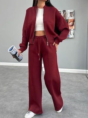 Crimson bomber jacket and wide-leg tracksuit with drawstring waist and zipper detail.