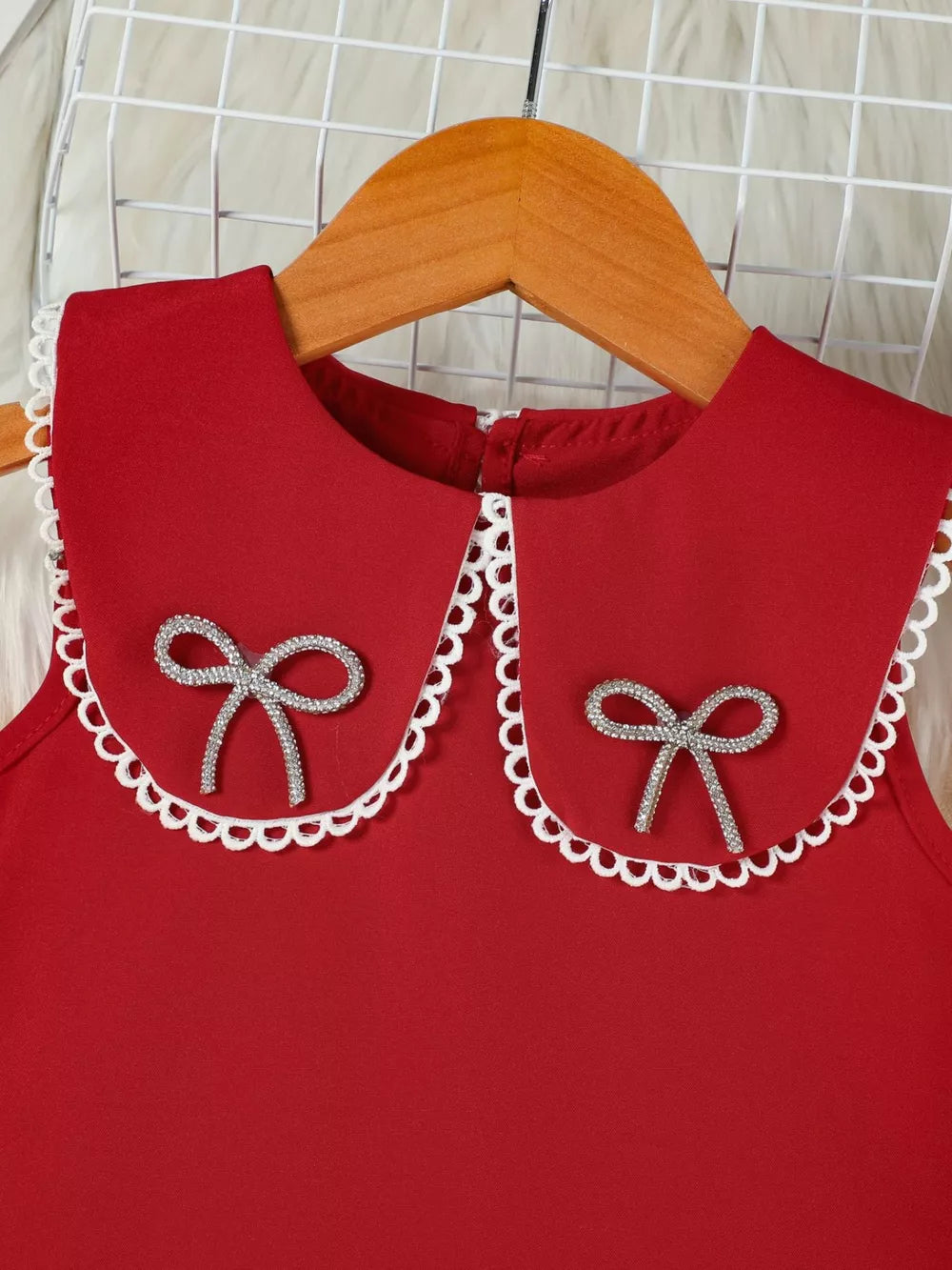 Red toddler dress with lace-trimmed collar and jeweled bows.