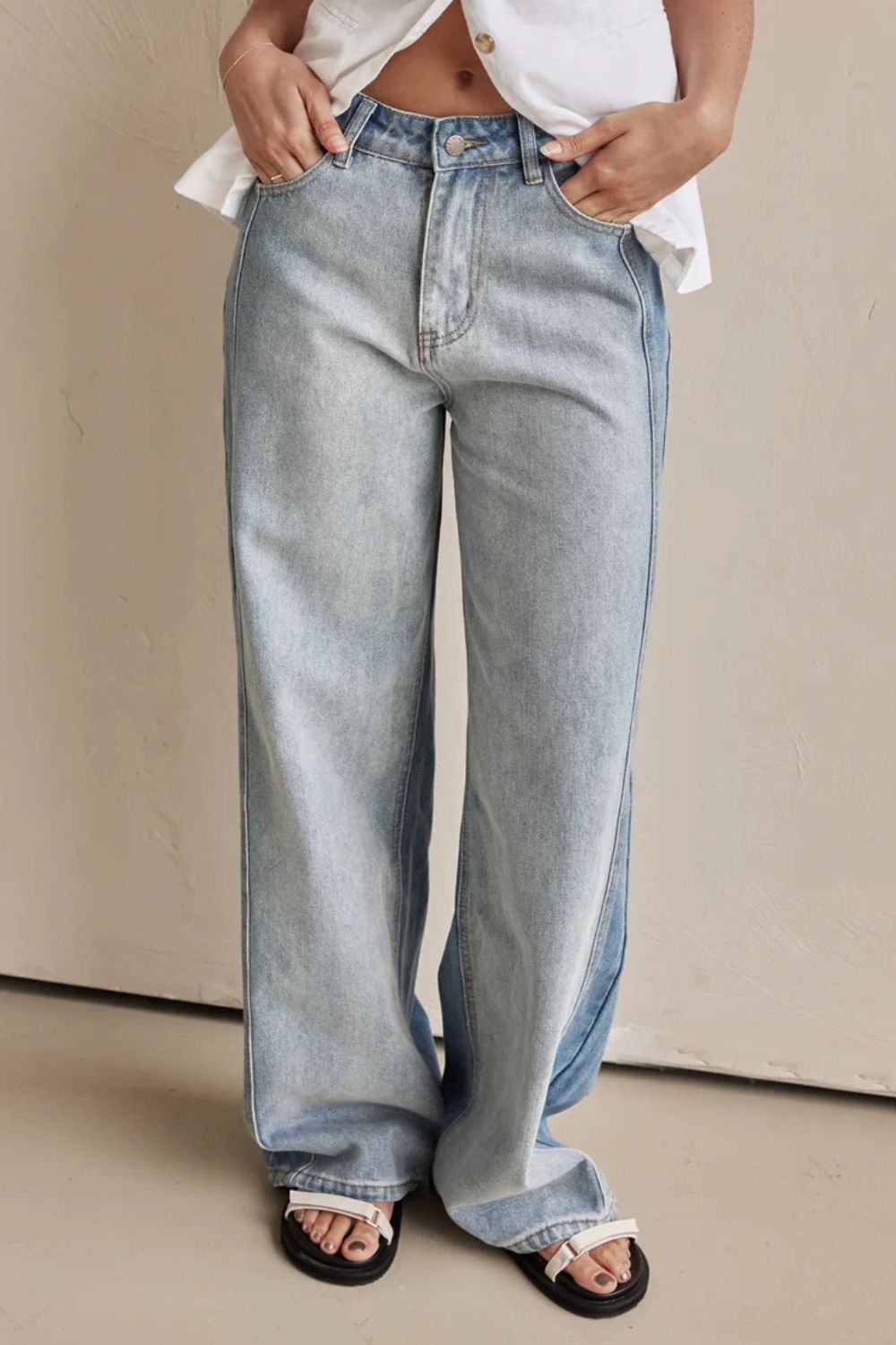Panelled wide-leg denim trousers in light wash with contrast stitching and a relaxed fit.