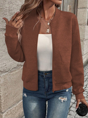 Caramel geometric quilted bomber jacket with zipper and ribbed cuffs.