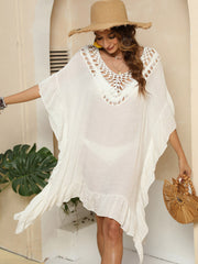 Ivory crochet yoke ruffle hem cover-up with V-neck and short sleeves.