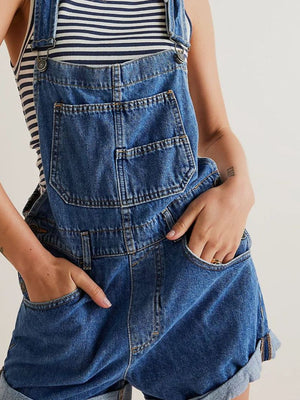 Medium wash denim overalls with a bib pocket and cuffed shorts.