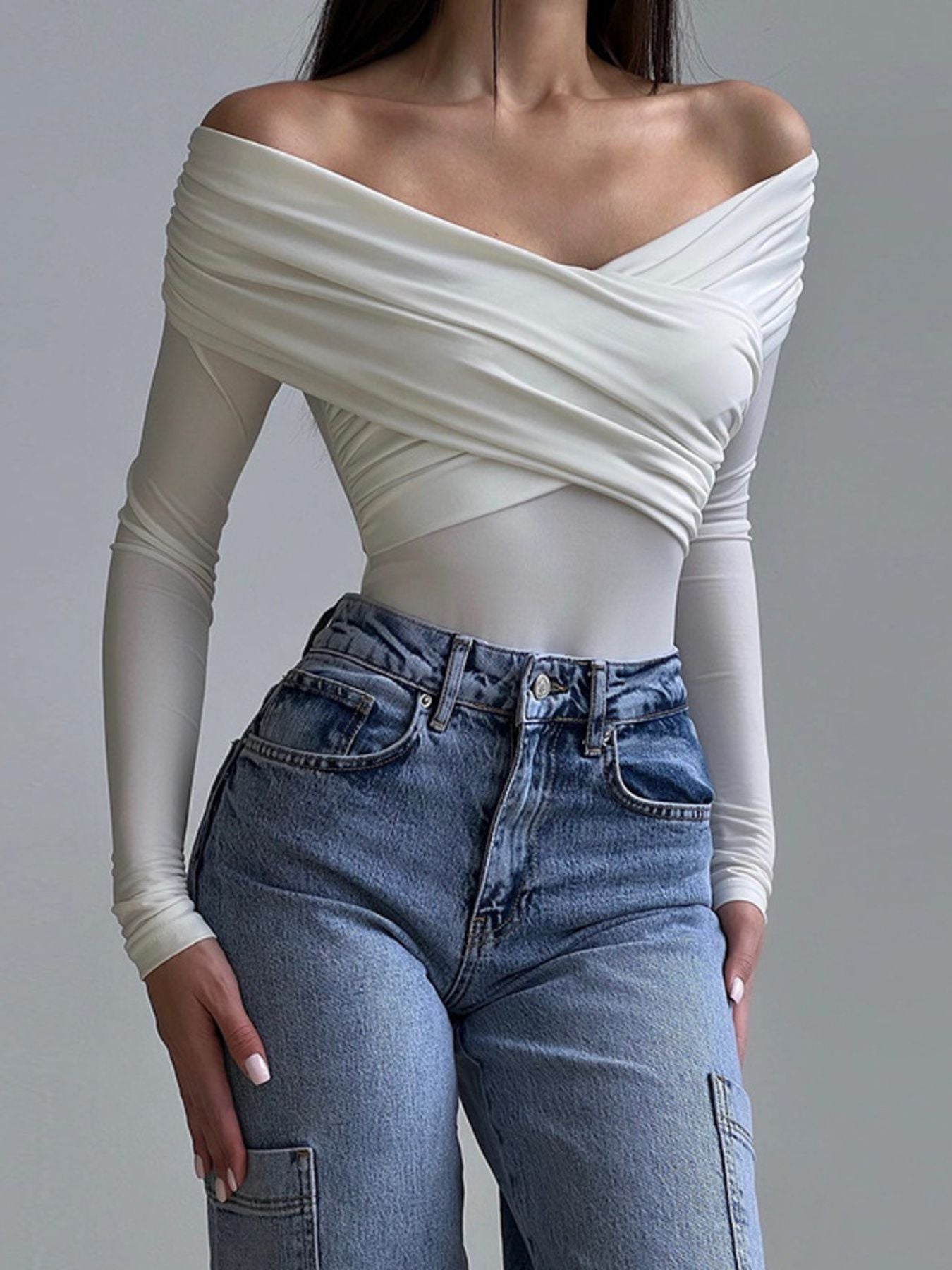 White off-shoulder long sleeve bodysuit with draped ruching and wrap detail