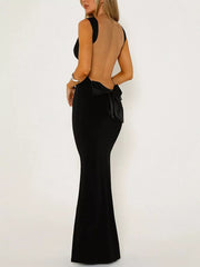 Black backless maxi dress with a large satin bow detail at the waist.