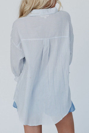 Light blue striped peplum blouse with a collared neckline and button-down back detail.