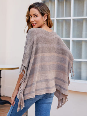 Striped fringe poncho in khaki with a boat neckline and relaxed fit.
