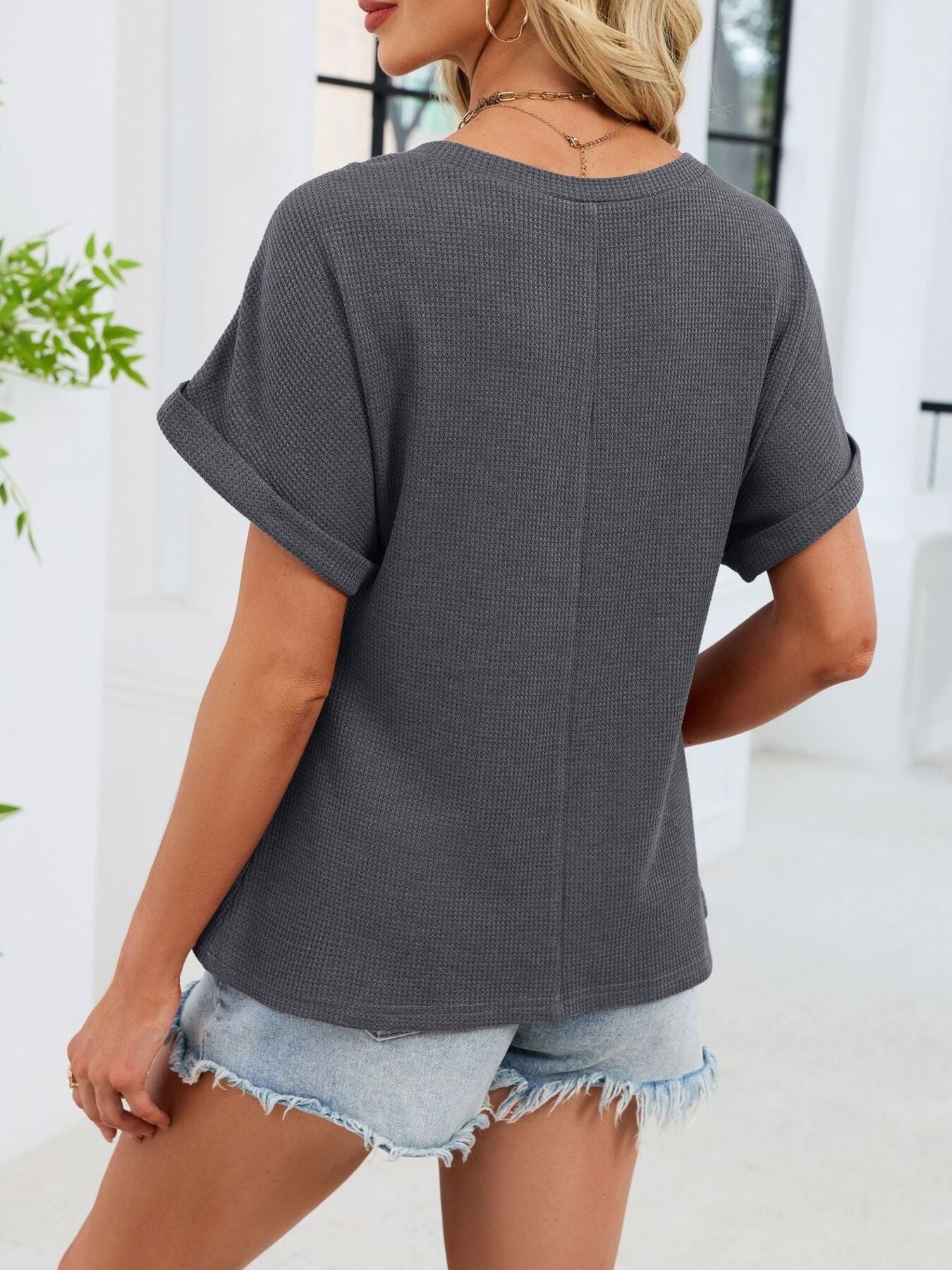 Gray waffle knit t-shirt with cuffed short sleeves and a relaxed fit.