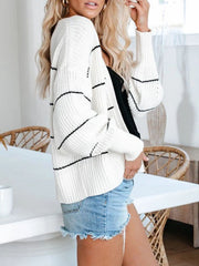 White open knit cardigan with horizontal black stripes, acrylic material, casual style.