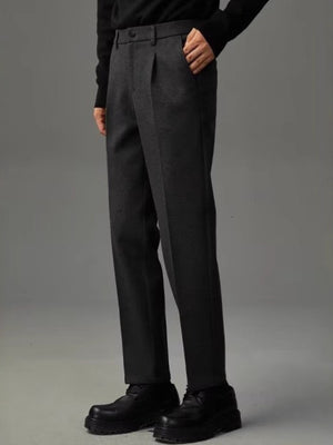 Men's dark gray premium pocketed trousers with a relaxed fit and pleated front.