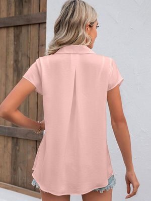 Blush pink textured collared shirt with short sleeves and a back pleat detail.