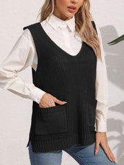 Black oversized knit vest with V-neck and patch pockets, styled over a white shirt.