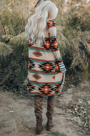 Southwestern print duster cardigan with stripe cuff sleeves and side slits.