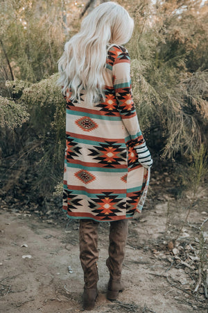 Southwestern print duster cardigan with stripe cuff sleeves and side slits.