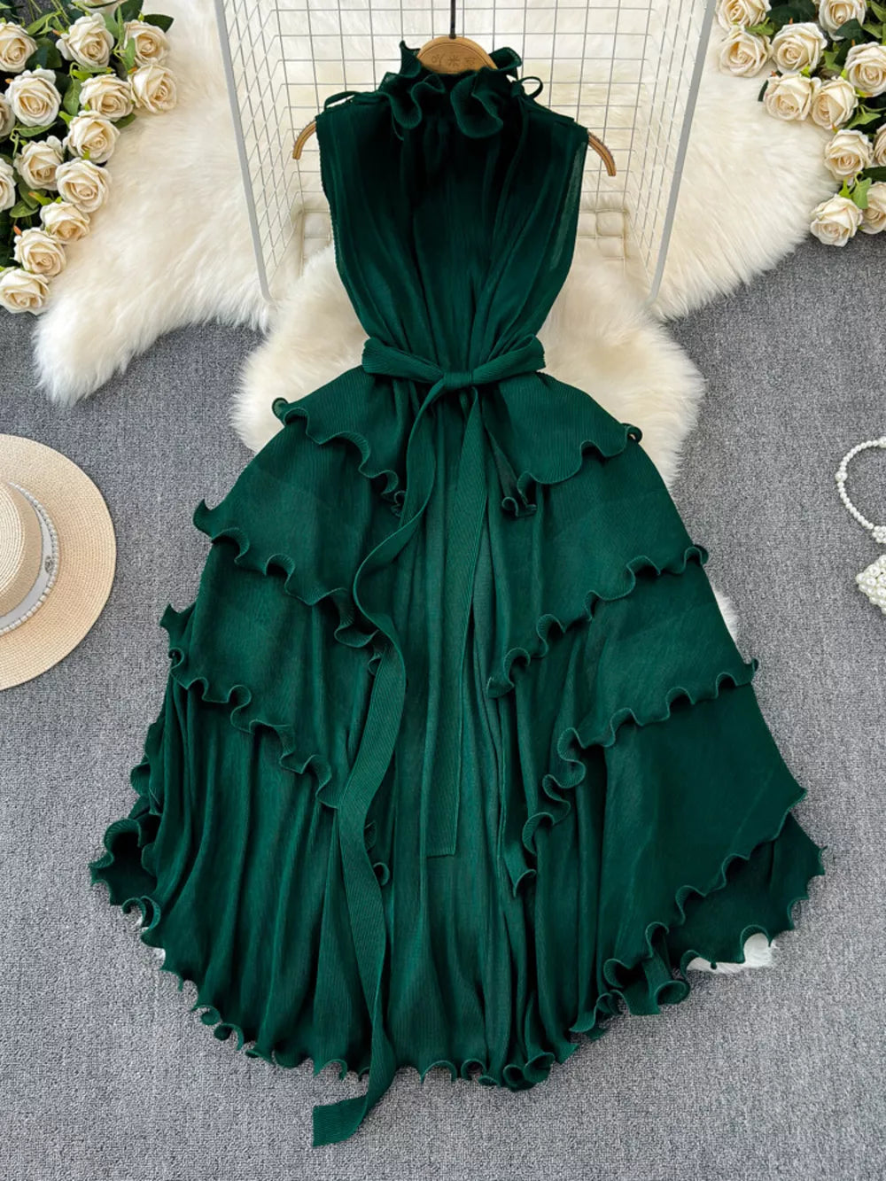 Dark green ruffled tiered midi dress with belted waist and frill neckline.
