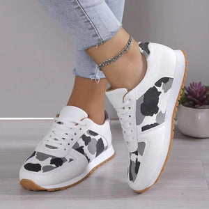 Leopard print panel runner sneakers in white with grey and black accents and gum sole.