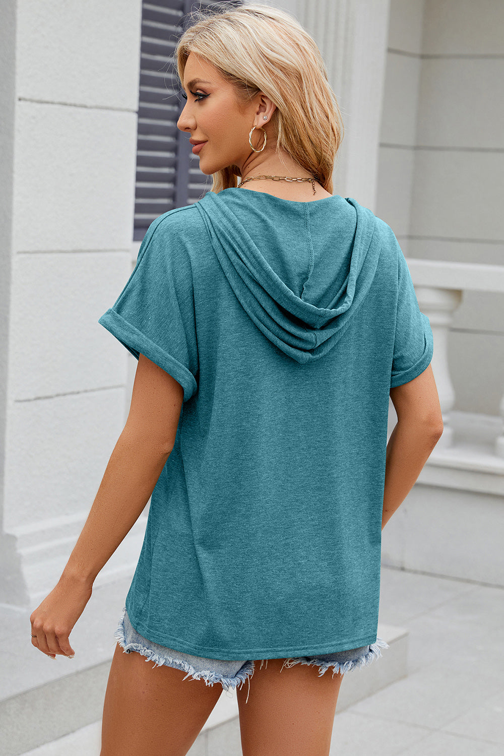 Turquoise Henley hooded tee with rolled short sleeves and a casual fit.