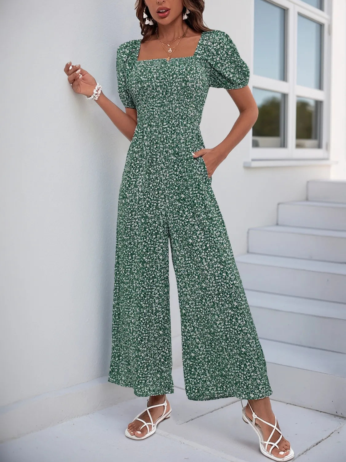 Dark Green floral smocked bodice jumpsuit with puff sleeves and wide legs.