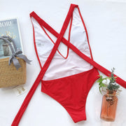 Red wrap-around halterneck plunge swimsuit with crisscross back straps.