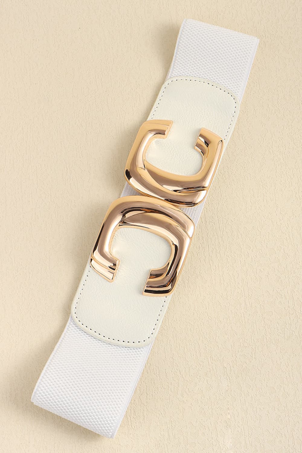 White elastic belt with gold double-C buckle detail