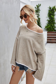 Oversized knit top in Sand with contrast white trim and off-the-shoulder neckline.