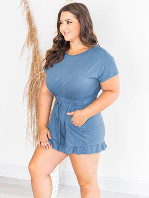 Light blue romper with short sleeves, drawstring waist, ruffle hem, and pockets.
