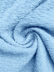 Smocked frill tube top in light blue textured fabric with buckle detail.