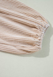Beige textured blouse with gathered sleeve detail and white ric-rac trim.