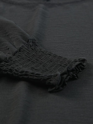 Black textured sleeve blouse with elastic smocked cuffs and ruffled hem detail.