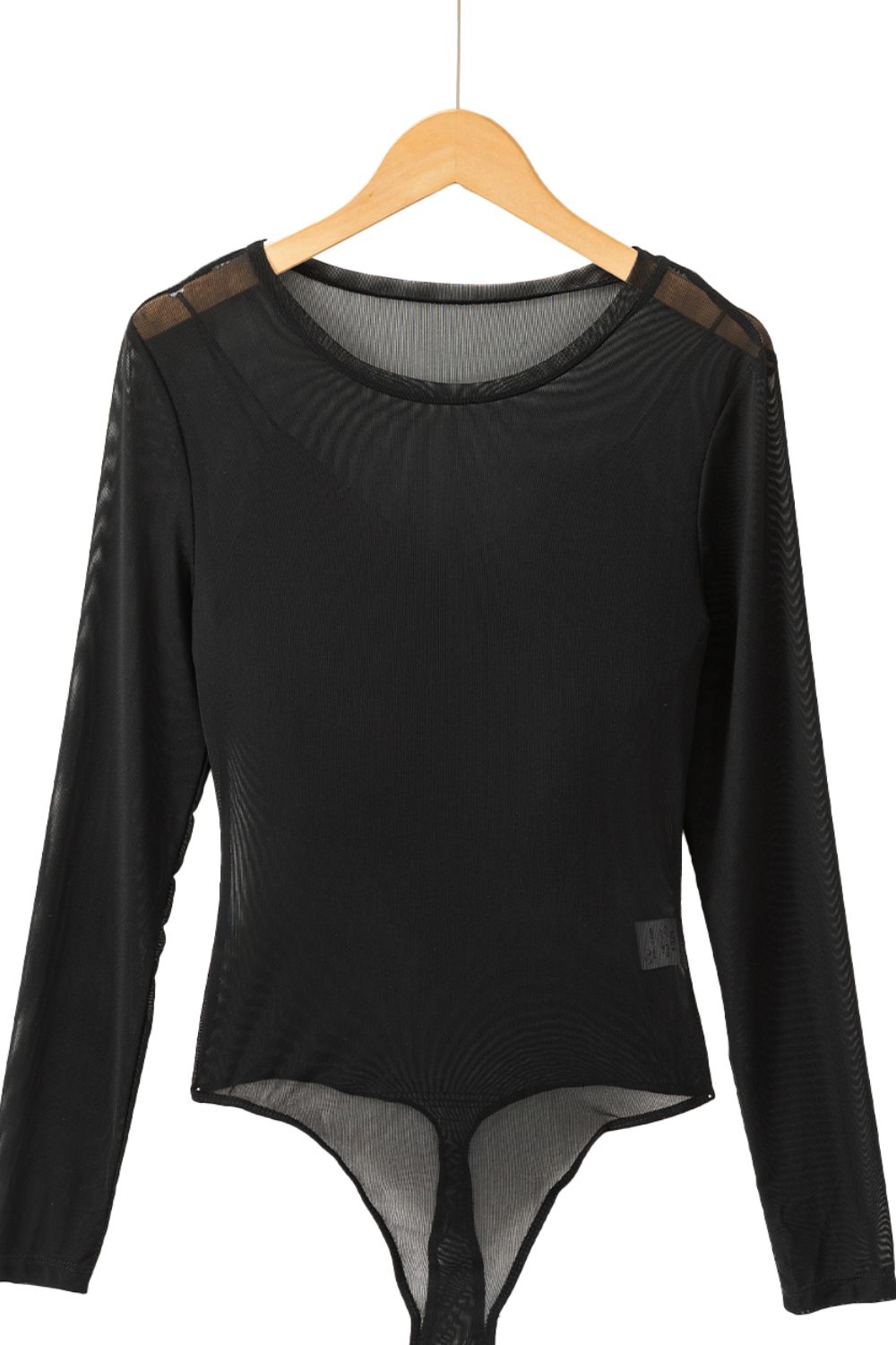 Black sheer mesh long sleeve bodysuit with a round neckline.