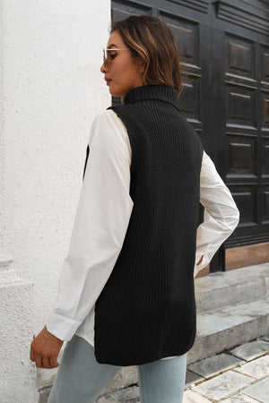 Black ribbed knit turtleneck vest with side buttons, acrylic, worn over a white shirt.