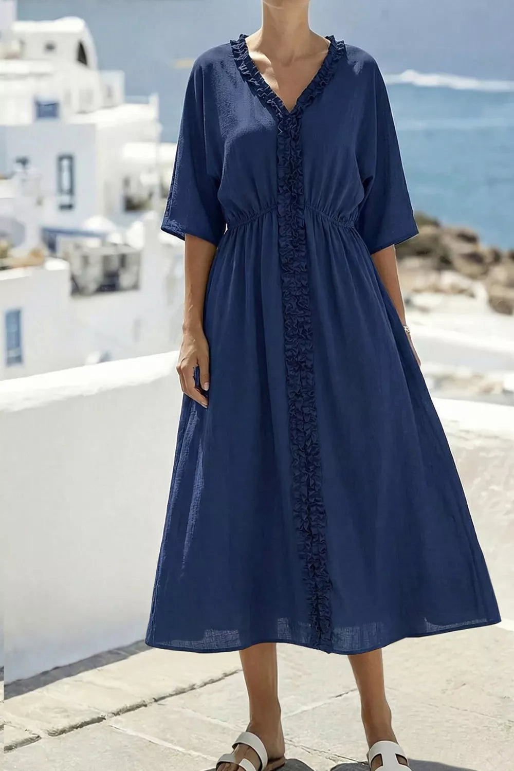 Navy blue ruffled V-neck midi dress with elastic waist and short sleeves.